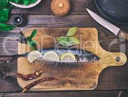 fresh mackerel on a wooden kitchen board