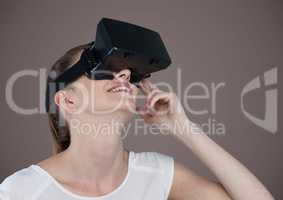 Woman in virtual reality headset against brown background