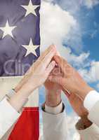hands high fiving against american flag