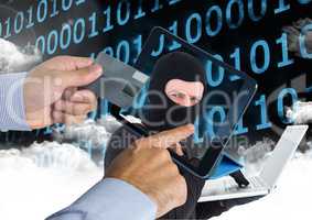 Man using a tablet with hacker head on screen  while holding a credit card