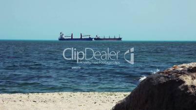 Large Cargo Shipping Boat moving along a seashore