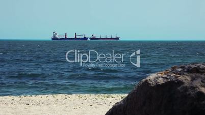 Large Cargos Shipping Boat moving along a seashore