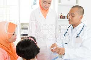 Doctor checking temperature of sick patient