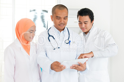 Medical team discussing on tablet pc