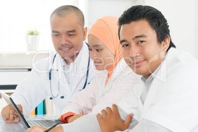 Doctors discussing at hospital office.