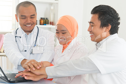 Medical doctors stacking hands