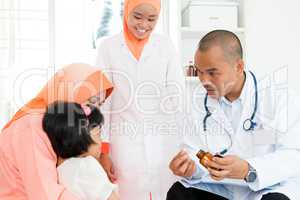 Doctor giving medicine to children
