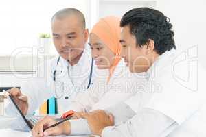 Asian doctors discussing at hospital office.