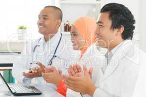 Asian doctors clapping hands