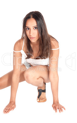 Lovely woman crouching on floor.