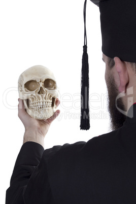 Young man in a graduate hat with a skull