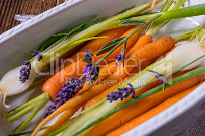 Young carrots and spring onions prepared for baking