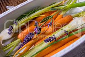 Young carrots and spring onions prepared for baking