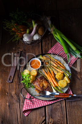 Grilled steak with vegetables and fried potatoes