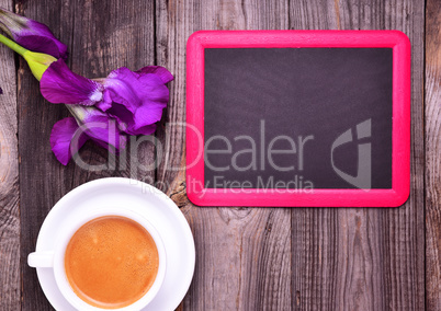 Empty black chalk board and white cup with cappuccino