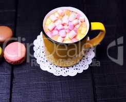 mug with cocoa and pieces of colorful marshmallow