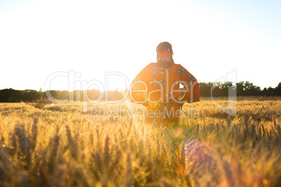 African woman in traditional clothes standing in a field of crop