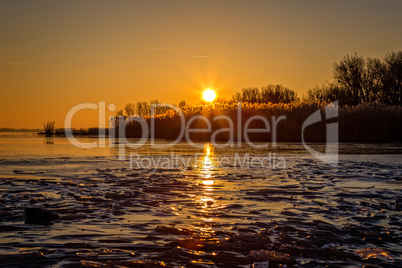 Beautiful sunset on a frozen lake Balaton in Hungary