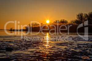 Beautiful sunset on a frozen lake Balaton in Hungary