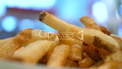Motion of fries on table at food court inside shopping mall