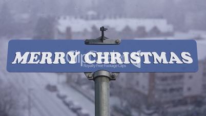 Merry Christmas road sign on cold blizzard snow winter time