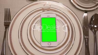 Motion of display tableware and green screen phone on plate