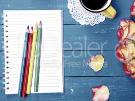 Empty notebook and colorful wooden pencils