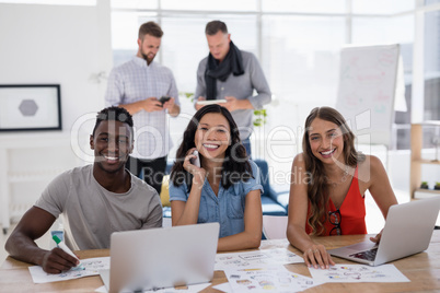 Young business colleagues working on laptop in the office