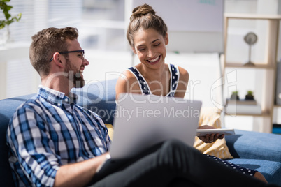 Executives interacting with each other while working together in the office