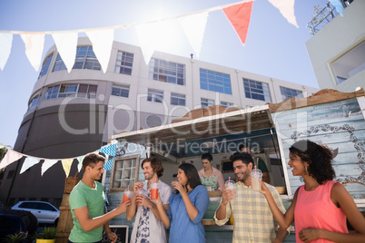 Friends interacting while having juice