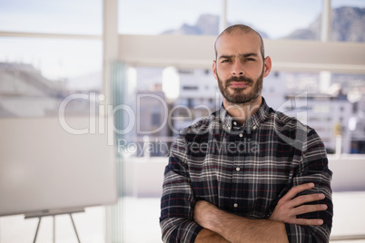 Portrait of confident executive standing with arms crossed