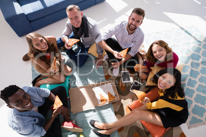 Group of happy executives having pizza