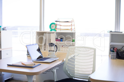 Laptop and other office belongings on table