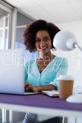 Female executive working over laptop