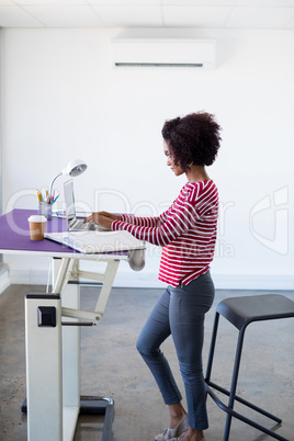 Female executive working over laptop