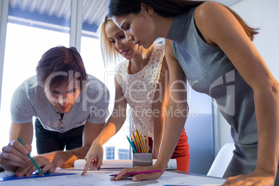 Architects working on blueprint at their desk