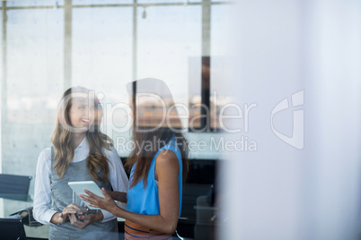 Female executives using digital tablet