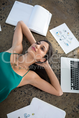 Female executive lying on the floor