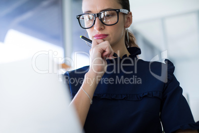 Female executive working over laptop at her desk