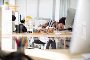 Female executive resting at her desk