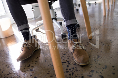 Male executive relaxing on chair in office