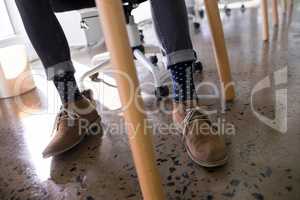 Male executive relaxing on chair in office