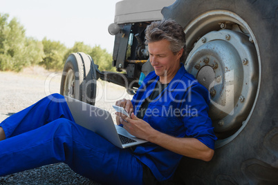 Worker using mobile phone and laptop