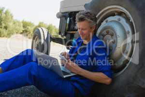 Worker using mobile phone and laptop