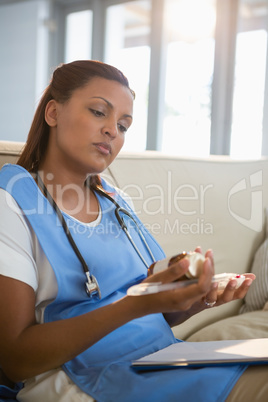 Doctor examining prescription pill bottle
