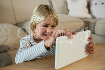 Boy using digital tablet in the living room