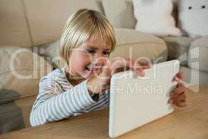 Boy using digital tablet in the living room