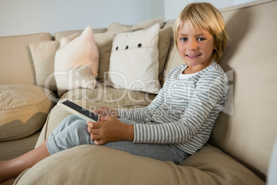 Boy using digital tablet in the living room at home