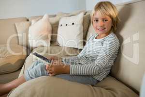 Boy using digital tablet in the living room at home