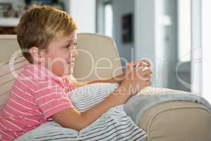 Boy playing video game in the living room